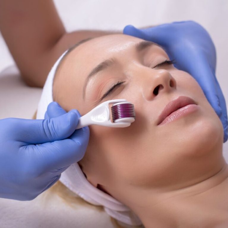 A doctor with rubber gloves doing a plastic face surgery on a happy young female